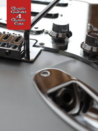 Close-up of a guitar's bridge and tuning pegs with 'Classic Guitars 4 Classic Cars' text.