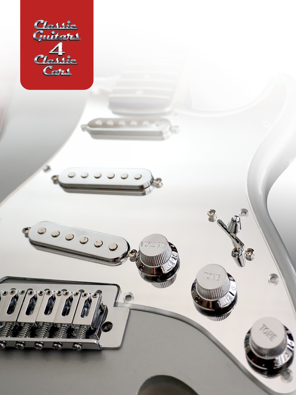 Close-up of a white electric guitar with visible hardware and a red 'Classic Guitars' logo.