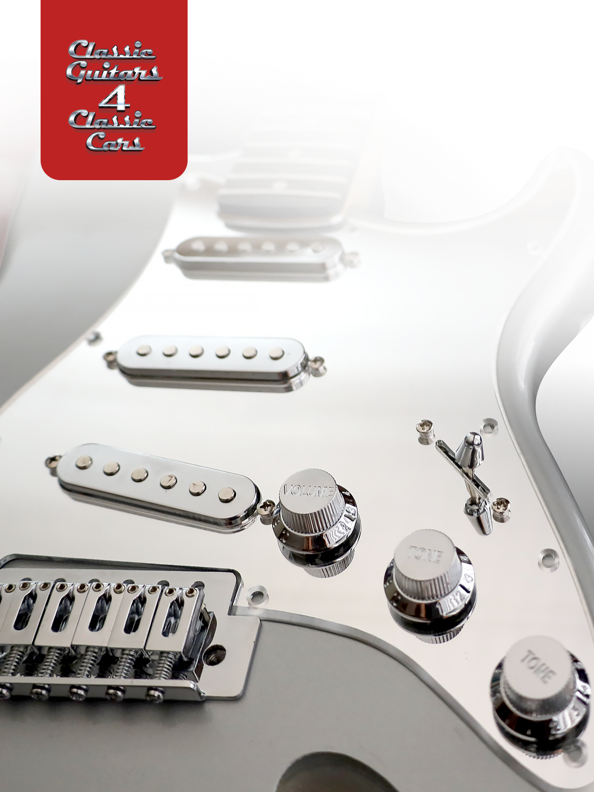 Close-up of a white electric guitar with visible hardware and a red 'Classic Guitars' logo.